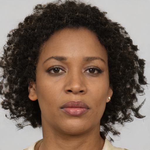 Neutral black young-adult female with medium  brown hair and brown eyes