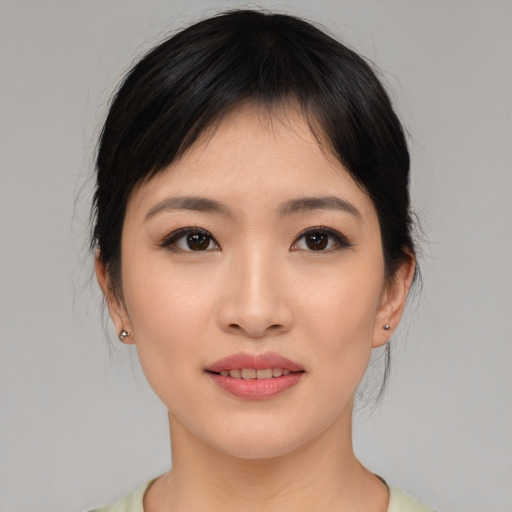Joyful asian young-adult female with medium  black hair and brown eyes