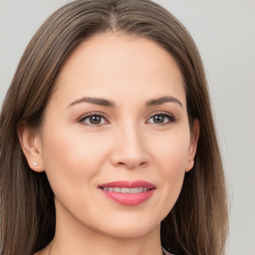 Joyful white young-adult female with long  brown hair and brown eyes