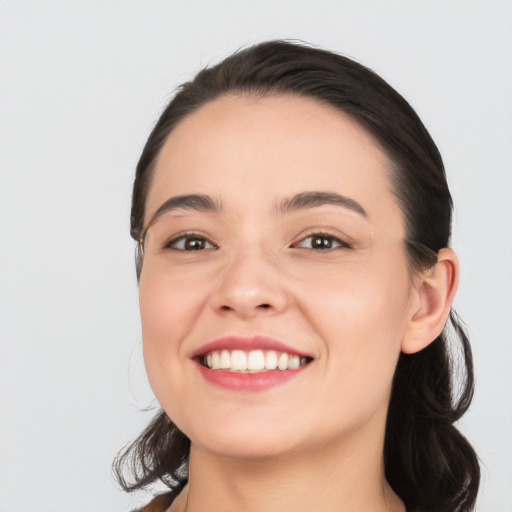 Joyful white young-adult female with medium  black hair and brown eyes