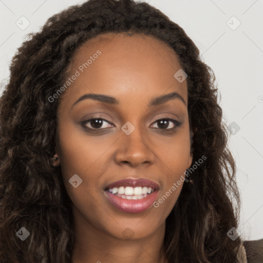 Joyful black young-adult female with long  brown hair and brown eyes