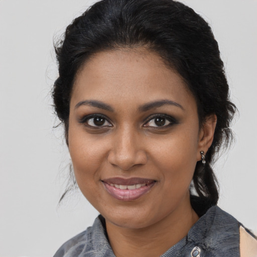 Joyful black young-adult female with medium  brown hair and brown eyes