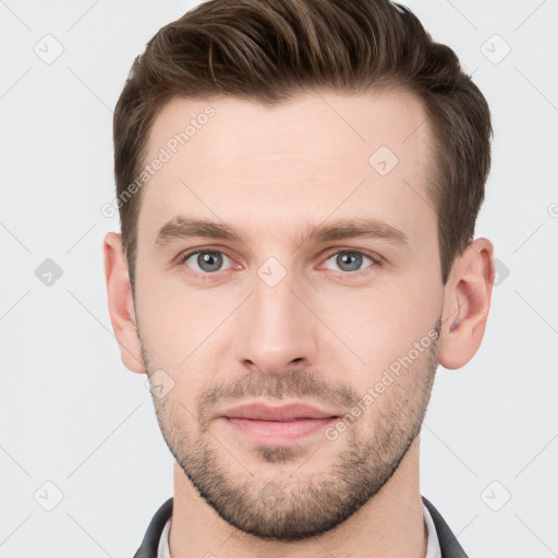 Joyful white young-adult male with short  brown hair and grey eyes