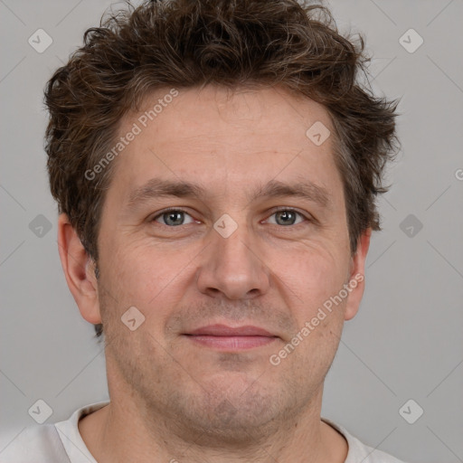 Joyful white adult male with short  brown hair and grey eyes