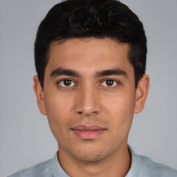 Joyful white young-adult male with short  black hair and brown eyes