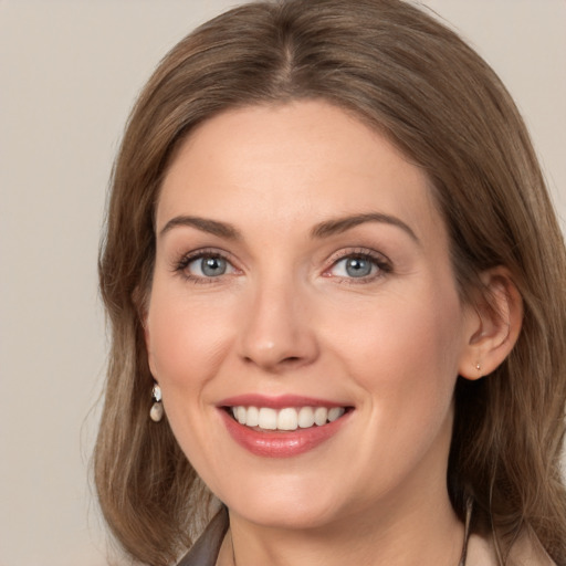 Joyful white young-adult female with medium  brown hair and grey eyes