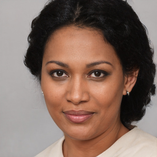 Joyful black young-adult female with medium  black hair and brown eyes
