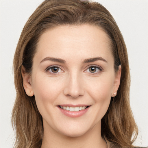 Joyful white young-adult female with long  brown hair and grey eyes