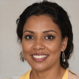 Joyful black adult female with medium  brown hair and brown eyes