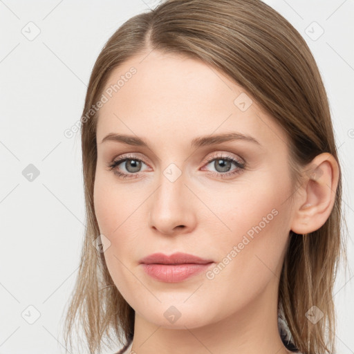 Joyful white young-adult female with long  brown hair and blue eyes