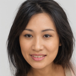 Joyful asian young-adult female with long  brown hair and brown eyes