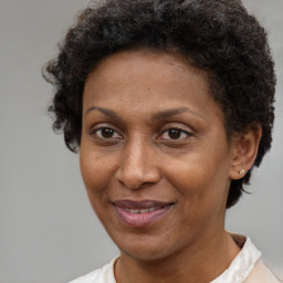 Joyful black adult female with short  brown hair and brown eyes