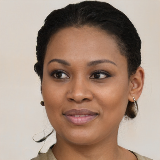 Joyful black young-adult female with short  black hair and brown eyes