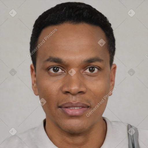 Joyful black young-adult male with short  black hair and brown eyes
