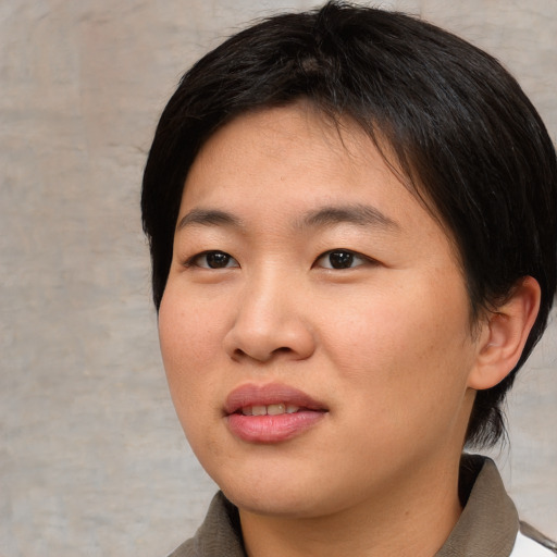Joyful asian young-adult female with short  black hair and brown eyes