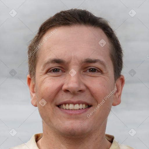 Joyful white adult male with short  brown hair and brown eyes