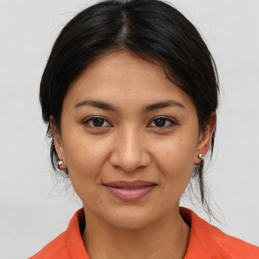 Joyful asian young-adult female with medium  brown hair and brown eyes