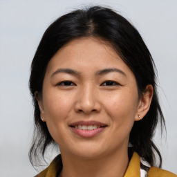 Joyful asian young-adult female with medium  brown hair and brown eyes