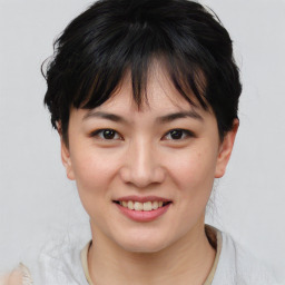 Joyful asian young-adult female with short  brown hair and brown eyes