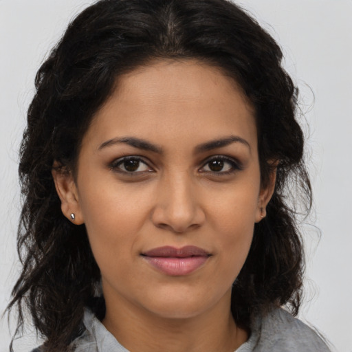 Joyful latino young-adult female with medium  brown hair and brown eyes