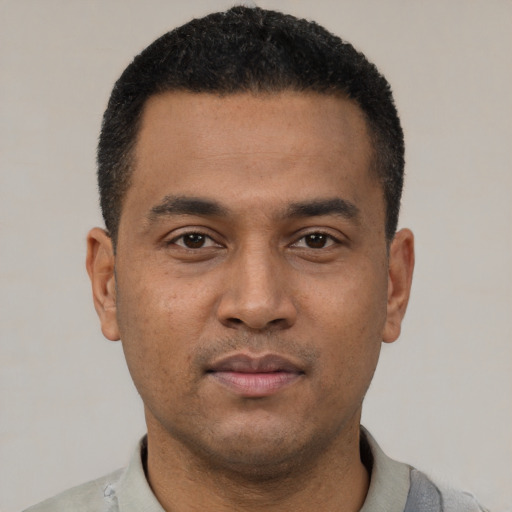 Neutral latino young-adult male with short  black hair and brown eyes