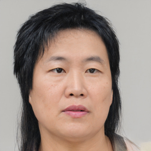 Neutral asian adult female with medium  brown hair and brown eyes