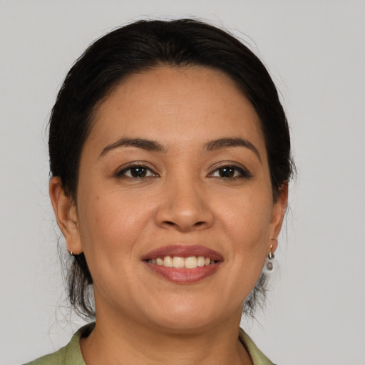 Joyful latino young-adult female with medium  brown hair and brown eyes