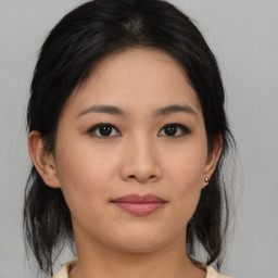 Joyful asian young-adult female with medium  brown hair and brown eyes