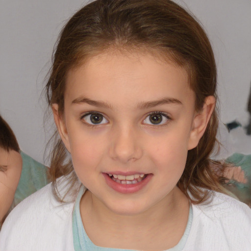 Joyful white child female with medium  brown hair and brown eyes