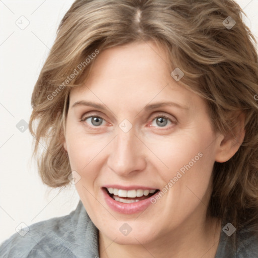 Joyful white young-adult female with medium  brown hair and blue eyes