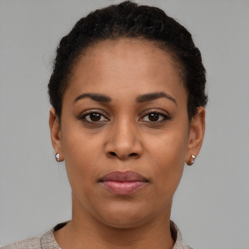 Joyful latino young-adult female with short  black hair and brown eyes
