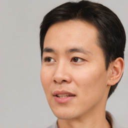 Joyful asian young-adult male with short  brown hair and brown eyes