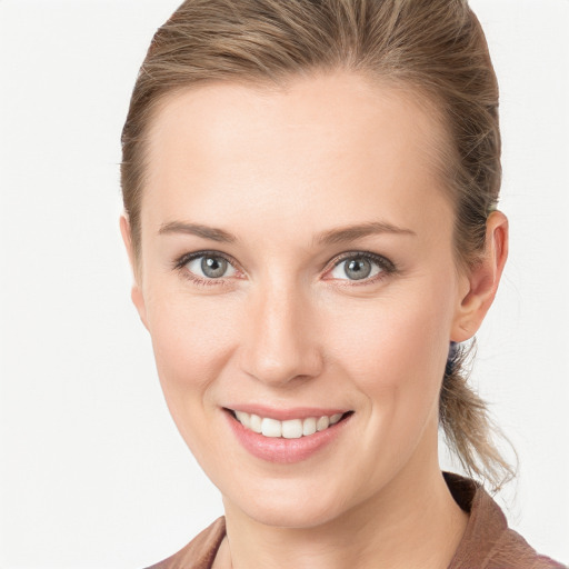 Joyful white young-adult female with medium  brown hair and blue eyes