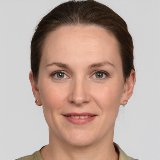 Joyful white adult female with short  brown hair and grey eyes