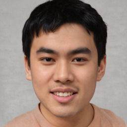 Joyful asian young-adult male with short  black hair and brown eyes