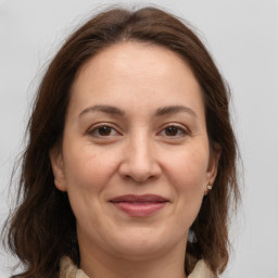 Joyful white adult female with medium  brown hair and brown eyes