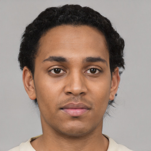 Neutral latino young-adult male with short  black hair and brown eyes