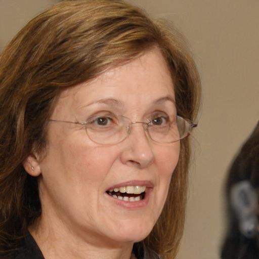 Joyful white middle-aged female with medium  brown hair and grey eyes