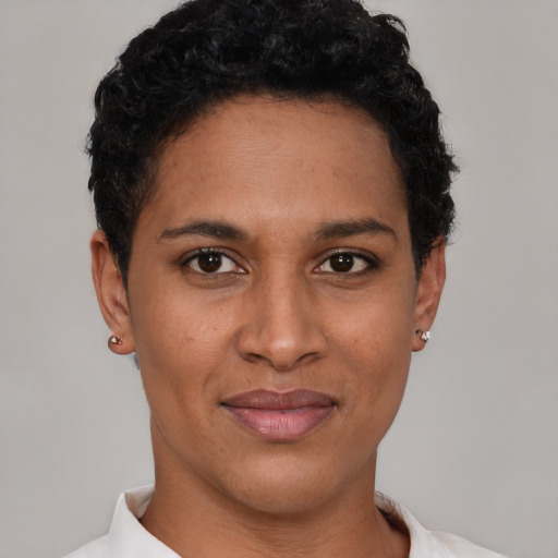 Joyful latino young-adult female with short  black hair and brown eyes