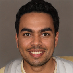 Joyful white young-adult male with short  black hair and brown eyes