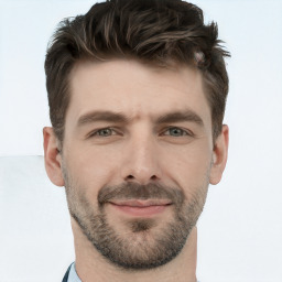 Joyful white young-adult male with short  brown hair and grey eyes