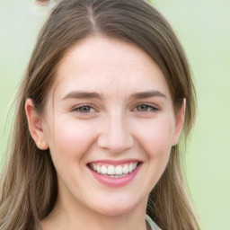 Joyful white young-adult female with long  brown hair and green eyes