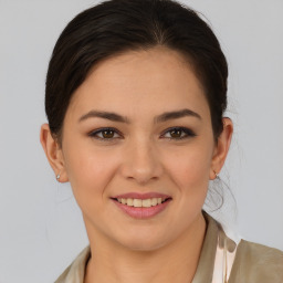 Joyful latino young-adult female with medium  brown hair and brown eyes