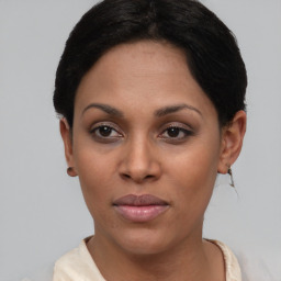 Joyful black young-adult female with short  brown hair and brown eyes