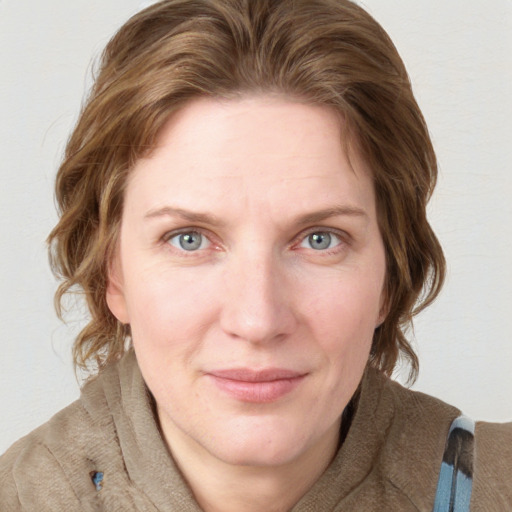 Joyful white young-adult female with medium  brown hair and blue eyes