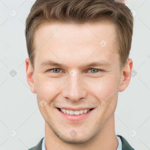 Joyful white young-adult male with short  brown hair and grey eyes