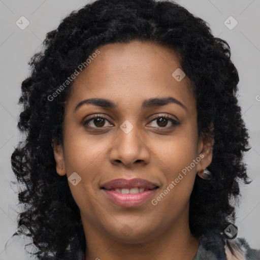 Joyful black young-adult female with long  black hair and brown eyes