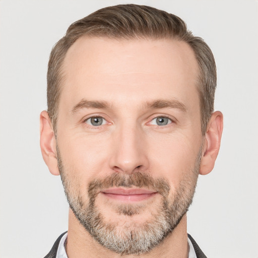 Joyful white adult male with short  brown hair and grey eyes