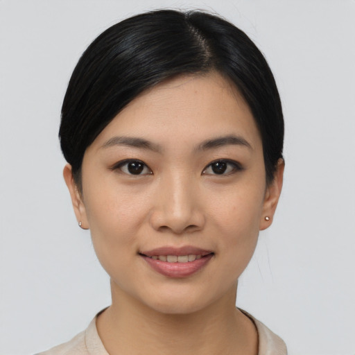 Joyful asian young-adult female with short  black hair and brown eyes