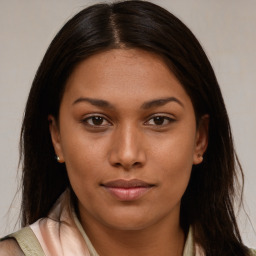 Joyful latino young-adult female with long  brown hair and brown eyes